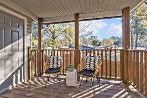 Wake Forest apartment for rent - Two chairs on a porch with a pillow on the back of each chair at West Oak Apartments, Wake Forest