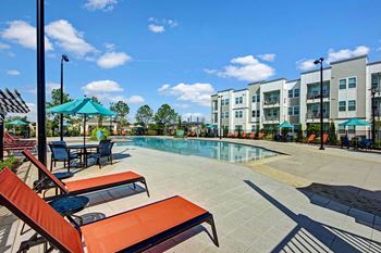 Beautiful swimming pool with deck chairs