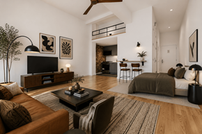 New York apartment for rent - A living room with a brown leather couch and a television on a wooden stand.