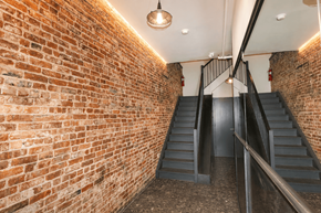 New York apartment for rent - A staircase with a metal railing and steps leading up to a door.