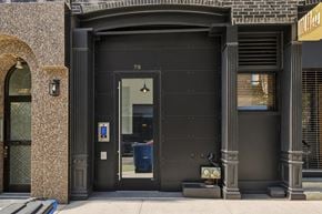 New York apartment for rent - A black door with the number 79 on it.