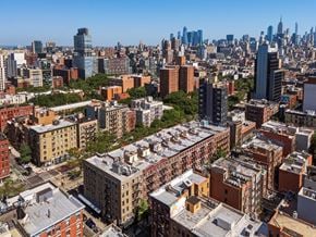 New York apartment for rent - A cityscape with a mix of modern and older buildings under a clear sky.