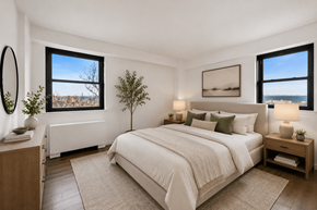 Atlantic Highlands apartment for rent - A bedroom with a large bed, a nightstand, and a window overlooking the ocean.