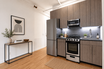 New York apartment for rent - A modern kitchen with a stove top oven and a refrigerator.