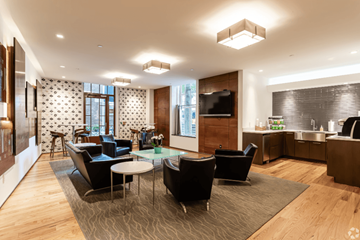 New Haven apartment for rent - A modern living room with a glass table and black chairs.