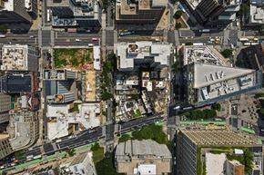 New York apartment for rent - A bird's eye view of a city with buildings, roads, and green spaces.