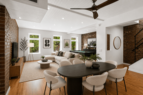 New York apartment for rent - A modern living room with a brick wall and a pool table.
