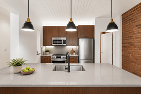 New York apartment for rent - A modern kitchen with a large island and pendant lights.