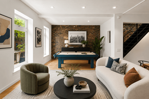 New York apartment for rent - A living room with a white couch, a green armchair, and a blue coffee table.