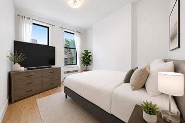 New York apartment for rent - A bedroom with a bed, a dresser, and a window.