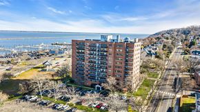 Atlantic Highlands apartment for rent - A large red brick building is in the middle of a parking lot.