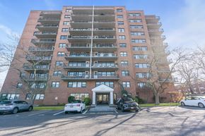 Atlantic Highlands apartment for rent - A large red brick apartment building with cars parked in front.
