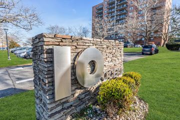 Atlantic Highlands apartment for rent - A stone pillar with a large circular metal piece on it.