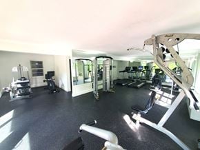 Norwich apartment for rent - A gym with a variety of equipment including a treadmill, weights, and a bench press.