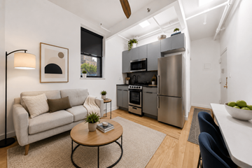 New York apartment for rent - A modern kitchen with a refrigerator, oven, and microwave.