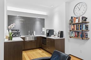 New Haven apartment for rent - A modern kitchen with a black chair and a clock on the wall.