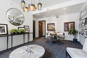 New Haven apartment for rent - A modern living room with a round mirror and a white sofa.