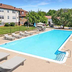 Baltimore townhouse for rent - a swimming pool with chairs around it and buildings in the background