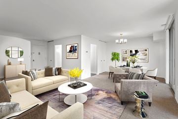 Laurel apartment for rent - A living room with a white coffee table and a grey couch.