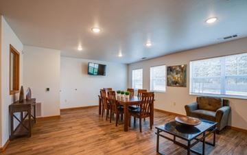 River Falls apartment for rent - A living room with a wooden floor and a television mounted on the wall.