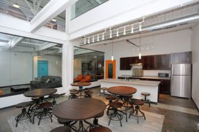 Wausau apartment for rent - A modern kitchen with a glass ceiling and a dining table with chairs.