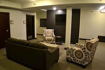 Eau Claire apartment for rent - A living room with a couch, two chairs and a television.