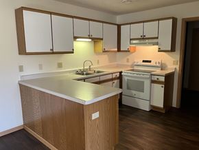 Ellsworth apartment for rent - A kitchen with wooden cabinets and a white counter.