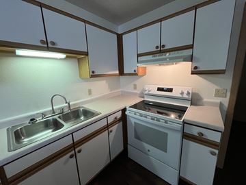 Ellsworth apartment for rent - A small kitchen with a white oven and sink.