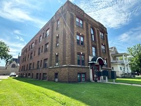 Winona apartment for rent - a brick building with a green lawn in front of it