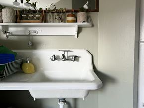 Winona apartment for rent - a white kitchen sink with a shelf above it