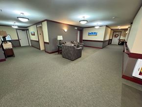 Cedar Rapids apartment for rent - Lobby / receiving area with a grey carpet and a grey sofa.