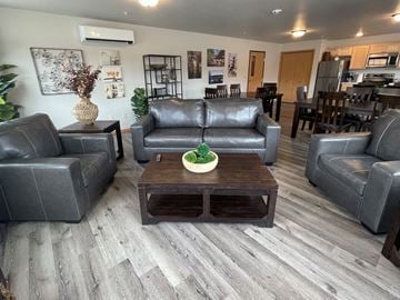 New Richmond apartment for rent - A living room with grey couches and a wooden coffee table.