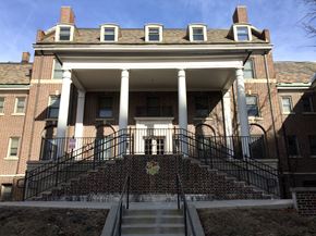 Des Moines apartment for rent - A large red brick building with a staircase leading to the front door.