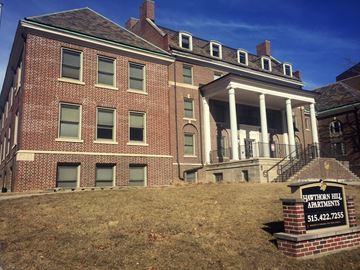Des Moines apartment for rent - A brick building with a sign in front that says Hawthorn Hill Apartments.