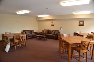 Ames apartment for rent - A living room with a brown carpet and furniture.