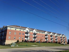 Ames apartment for rent - Apartment building with red brick and white trim.