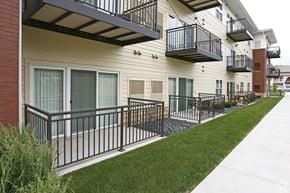 Rochester apartment for rent - A row of townhouses with balconies and black railings.
