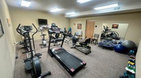 Winona apartment for rent - A room full of exercise equipment including treadmills, stationary bikes, and weights.