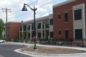 Osceola apartment for rent - A street lamp stands in front of a building.