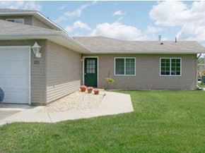 Chatfield apartment for rent - A house with a grey siding and a green door.