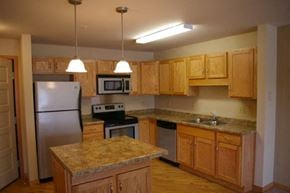 Osceola apartment for rent - A kitchen with wooden cabinets and granite countertops.