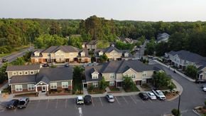 Durham apartment for rent - A parking lot in front of a building with cars parked.