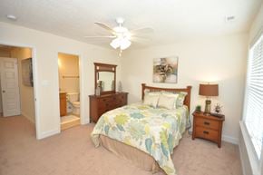 Durham apartment for rent - A bedroom with a bed, dresser, and mirror.