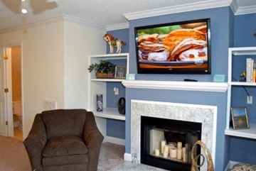 Durham apartment for rent - A living room with a fireplace and a television on the wall.