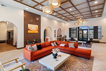 Buckeye apartment for rent - A living room with a red couch and a white coffee table.