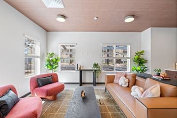 Flagstaff apartment for rent - A living room with a red chair and a brown couch.