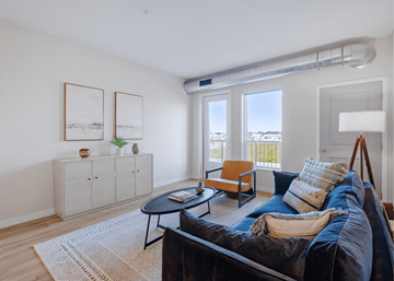 Blaine apartment for rent - A living room with a black couch and a wooden cabinet.