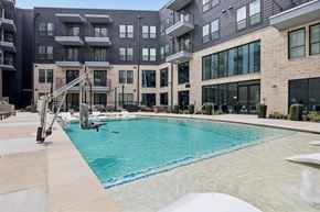 Farmers Branch apartment for rent - Luxury outdoor swimming pool at The Elara in Farmers Branch, TX with resort-inspired design and poolside loungers near Dallas