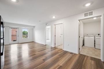Buffalo apartment for rent - A room with wooden floors and white walls.