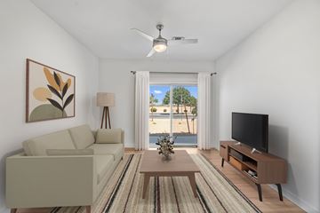 Maricopa apartment for rent - A living room with a couch, a coffee table, a television, and a painting on the wall.